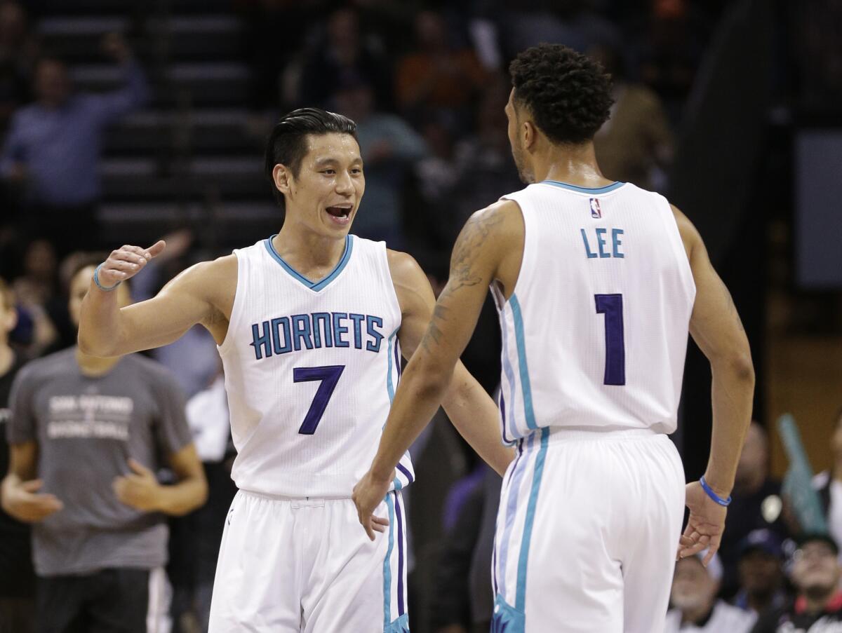 Charlotte guard Jeremy Lin (7) celebrates with Courtney Lee (1) during the second half of the Hornets' 91-88 victory over the Spurs on March 21.