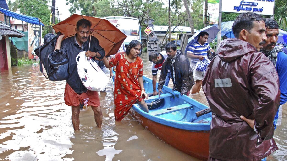 People are evacuated in Kozhikode, in the southern Indian state of Kerala, on Thursday.