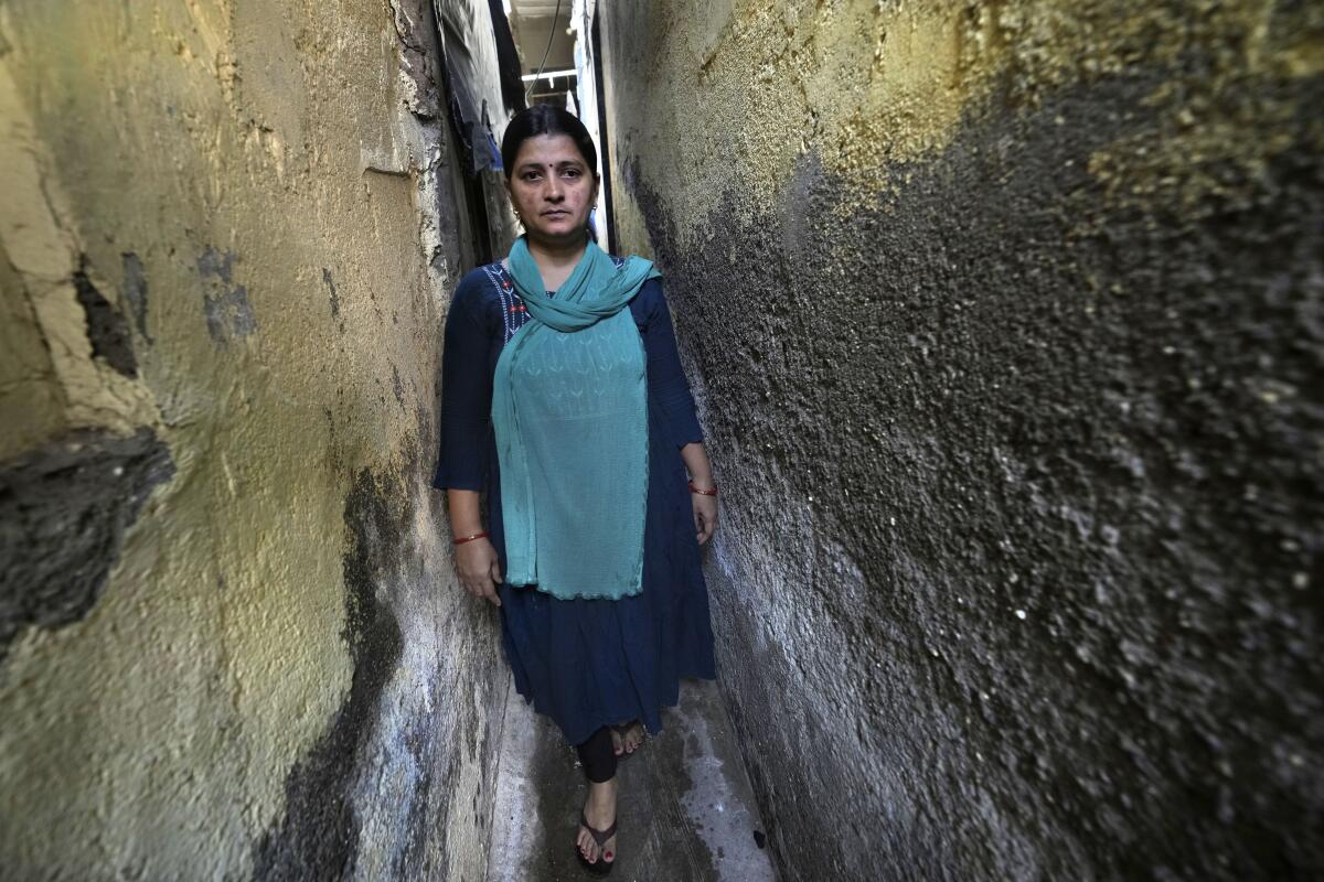 A woman stands in a narrow.