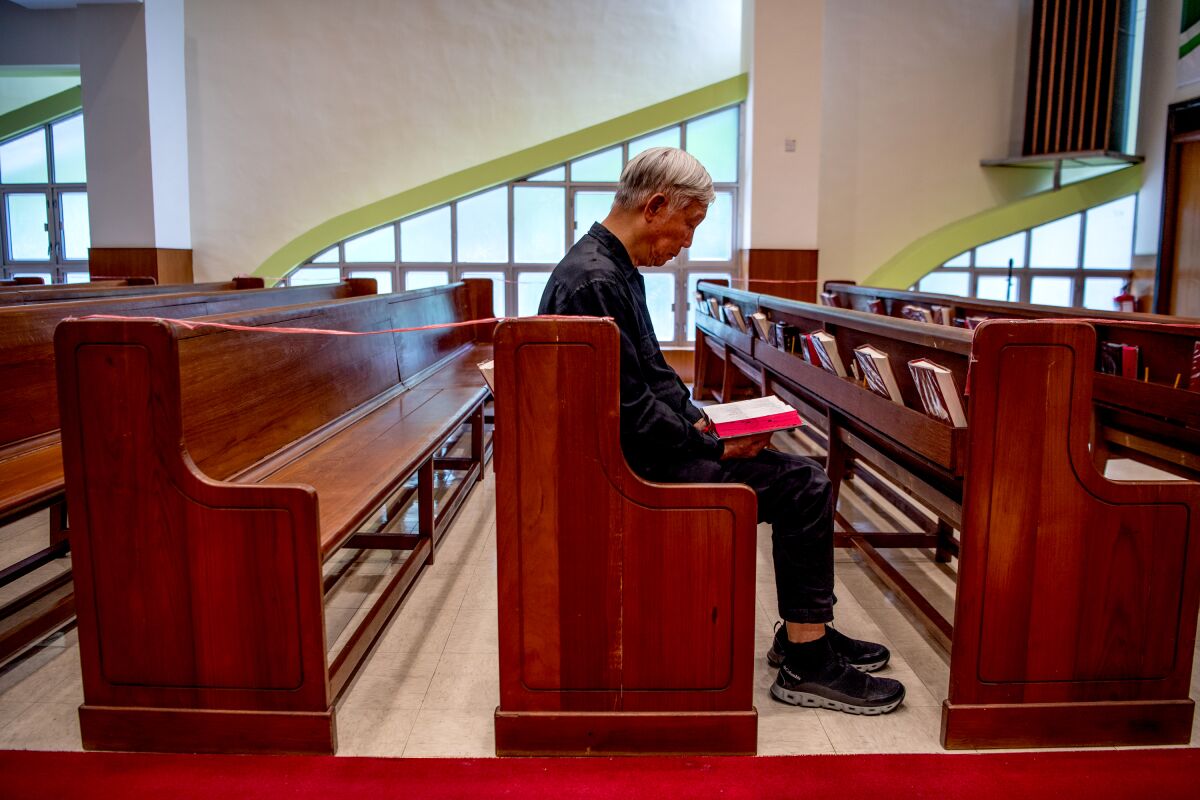 A person reads the Bible in a church.