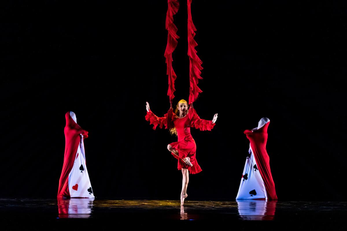 Dancers performing an "Alice in Wonderland"-inspired acrobatics.