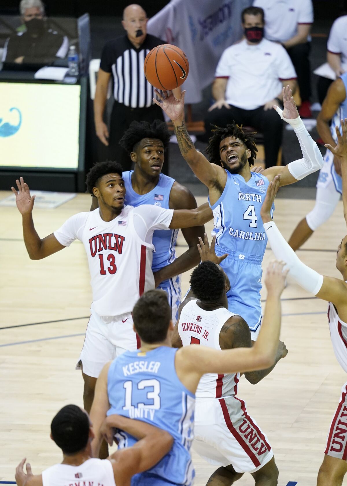 North Carolina guard R.J. Davis leaps to shoot a basket over UNLV guard Bryce Hamilton.
