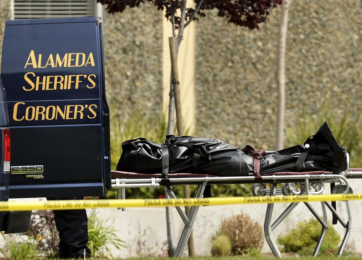 A body is loaded into an Alameda County coroner's van in Oakland in 2012. Coroners around the state are wondering about procedural issues under the new law allowing assisted death for terminally ill Californians.