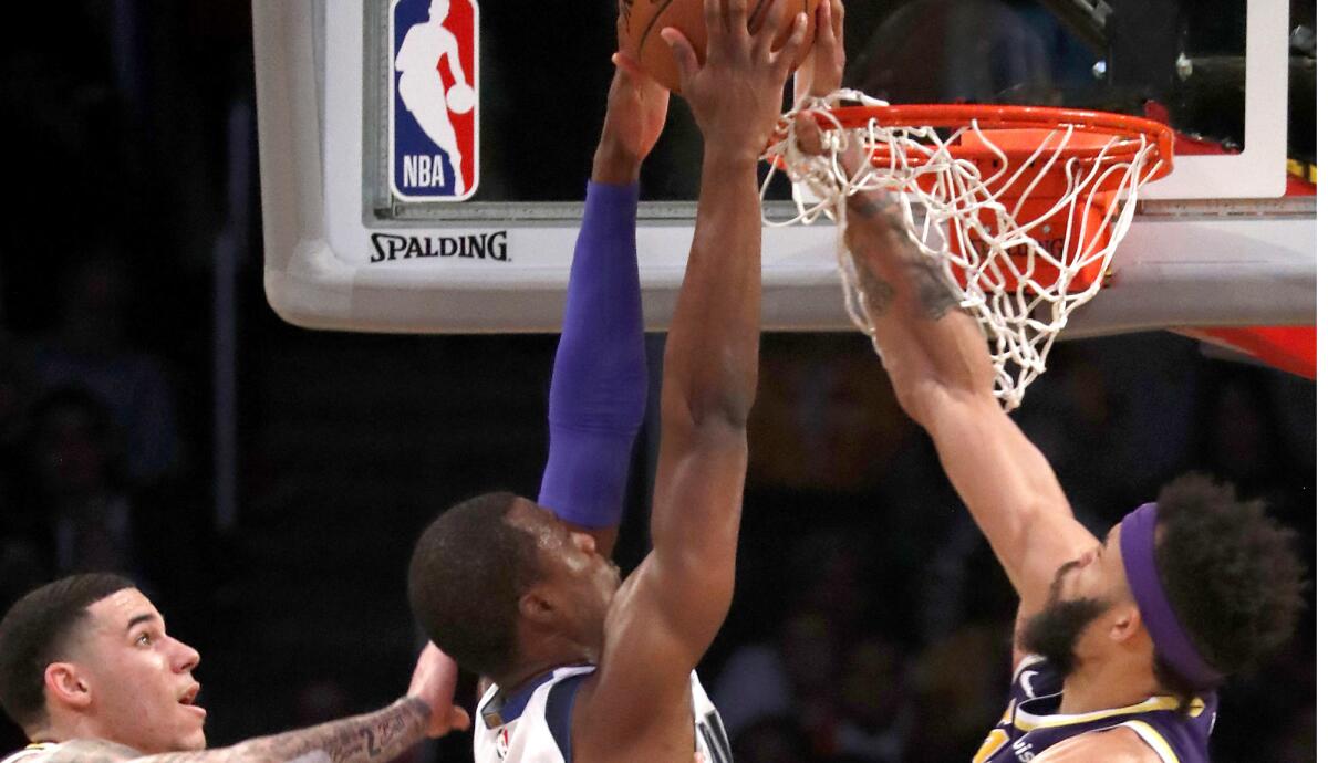 Lakers center JaVale McGee blocks a shot by Mavericks forward Harrison Barnes during the second quarter Wednesday.