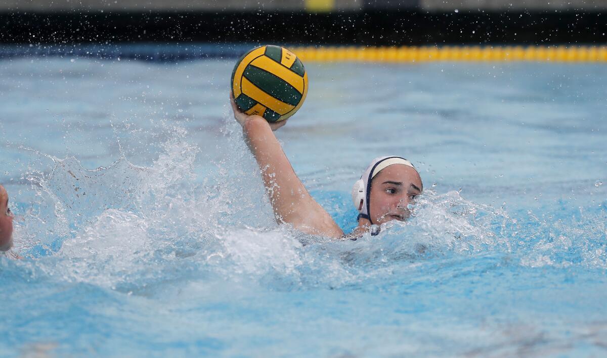 Flintridge Prep's Natalie Kaplanyan scores against Marina during the first half in the CIF Southern Section Division VI championship match at Woollett Aquatics Center in Irvine on Saturday.