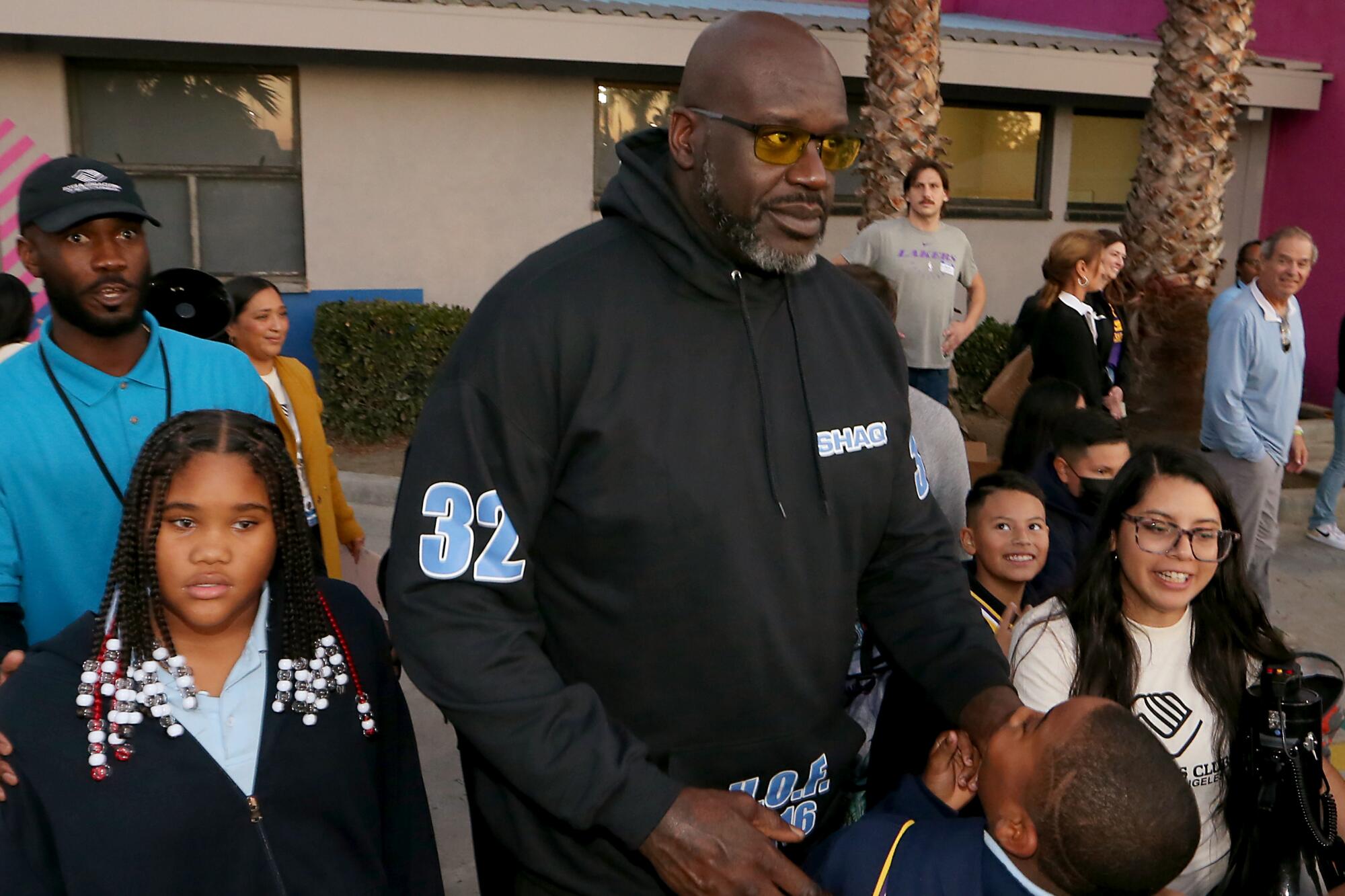 Shaquille O'Neal meets with kids during the unveiling of a new basketball court at the Challengers Boys & Girls Club.