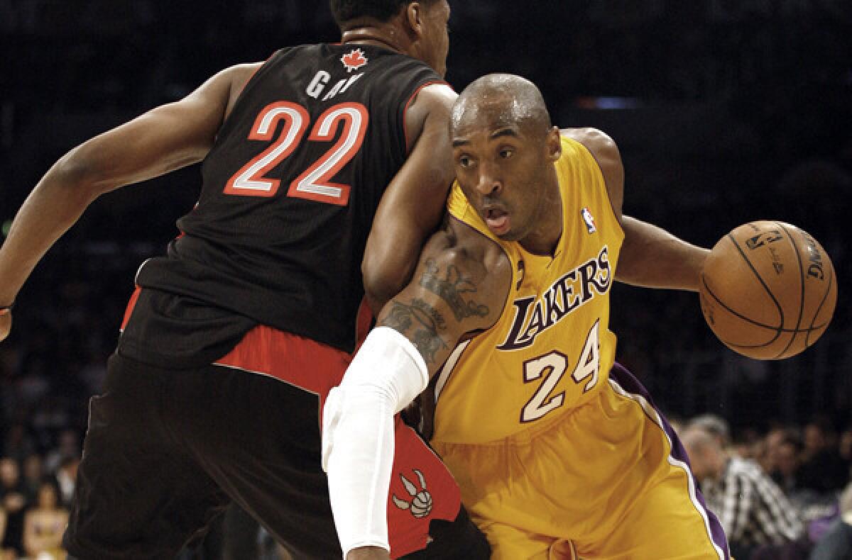 Lakers guard Kobe Bryant makes his debut Sunday night against the Raptors. Above, Bryant dribbles past Raptors forward Rudy Gay in a game last season.