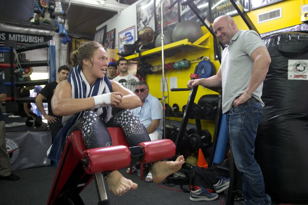 Ronda Rousey chats with UFC President Dana White during a workout at Glendale Fighting Club on July 15.