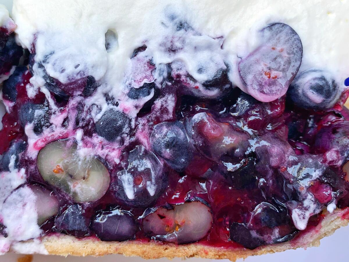 A simple cornstarch-thickened syrup gels together raw blueberries in this refreshing pie topped with fluffy whipped cream.