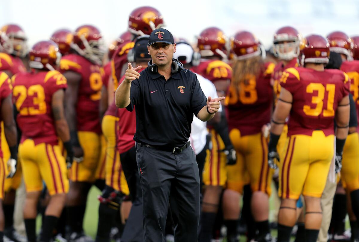 USC Coach Steve Sarkisian leads the Trojan squad against Idaho in the second quarter on Saturday at the Coliseum.
