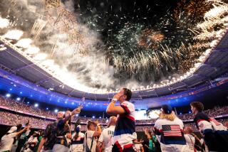 Olympic athletes watch as fireworks light up State de France during the Paris Olympics closing ceremony on Sunday.