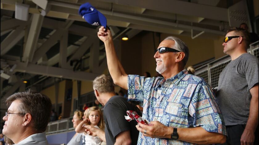 Craig Coley, 71, of Carlsbad proudly waves his Dodgers ballcap at the Padres-Dodgers game Monday at Petco Park. It was the first ballgame he's attended in nearly 48 years. He was exonerated last fall after spending nearly 40 years in prison for two murders he did not commit.