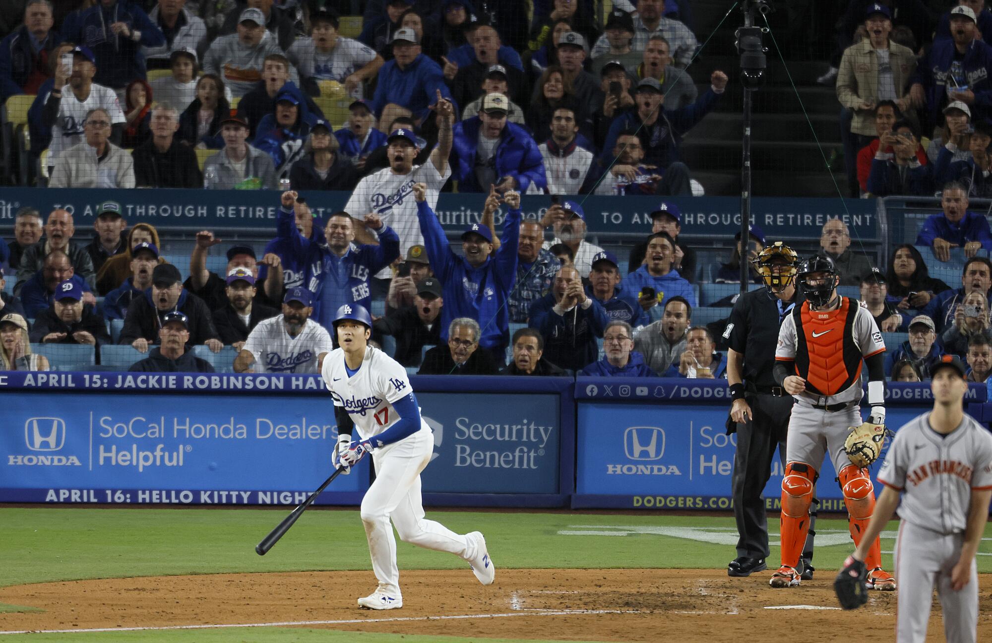 Dodgers' Shohei Ohtani watches his home run ball soar.