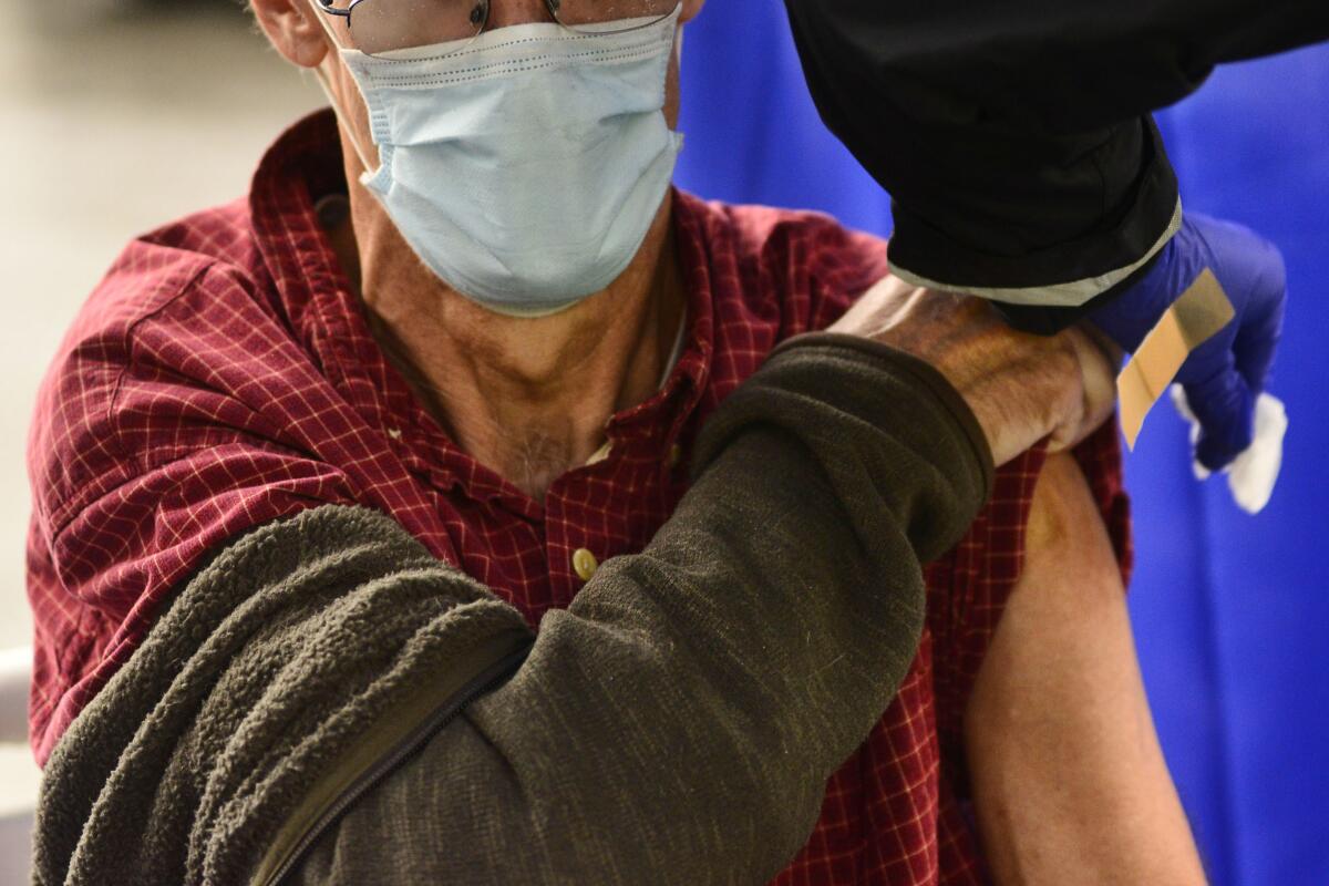 A man bares an arm for a flu shot. 