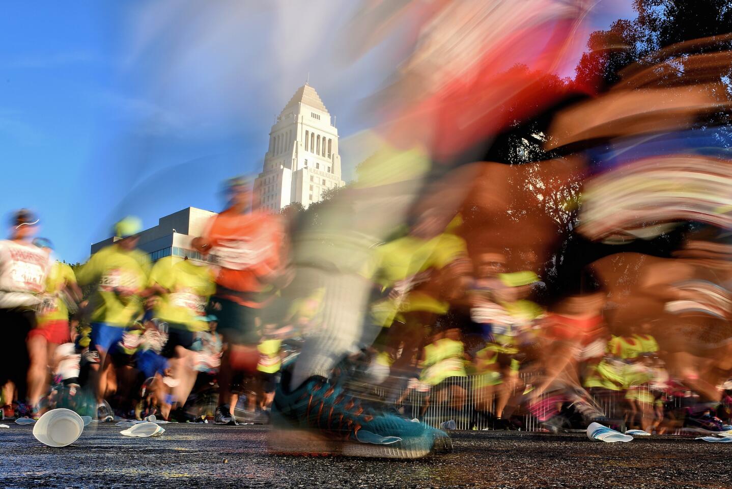 LOS ANGELES, CA - FEBRUARY 14: Participants run near Los Angeles City Hall during the 2016 Skechers Performance Los Angeles Marathon on February 14, 2016 in Los Angeles, California. (Photo by Jonathan Moore/Getty Images) ** OUTS - ELSENT, FPG, CM - OUTS * NM, PH, VA if sourced by CT, LA or MoD **
