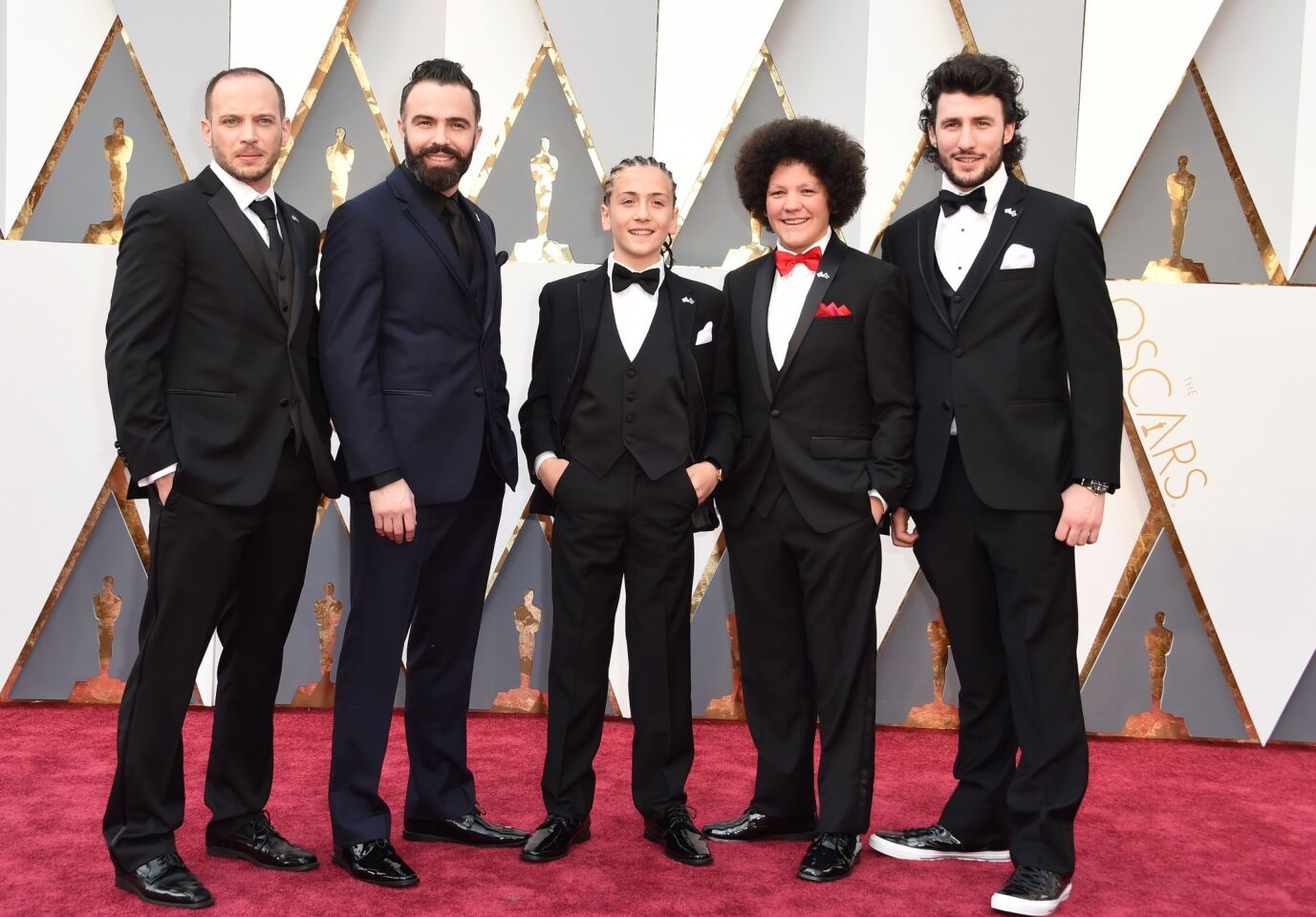 Members of the nominated live-action short feature "Shok" arrive on the red carpet for the 88th Academy Awards.