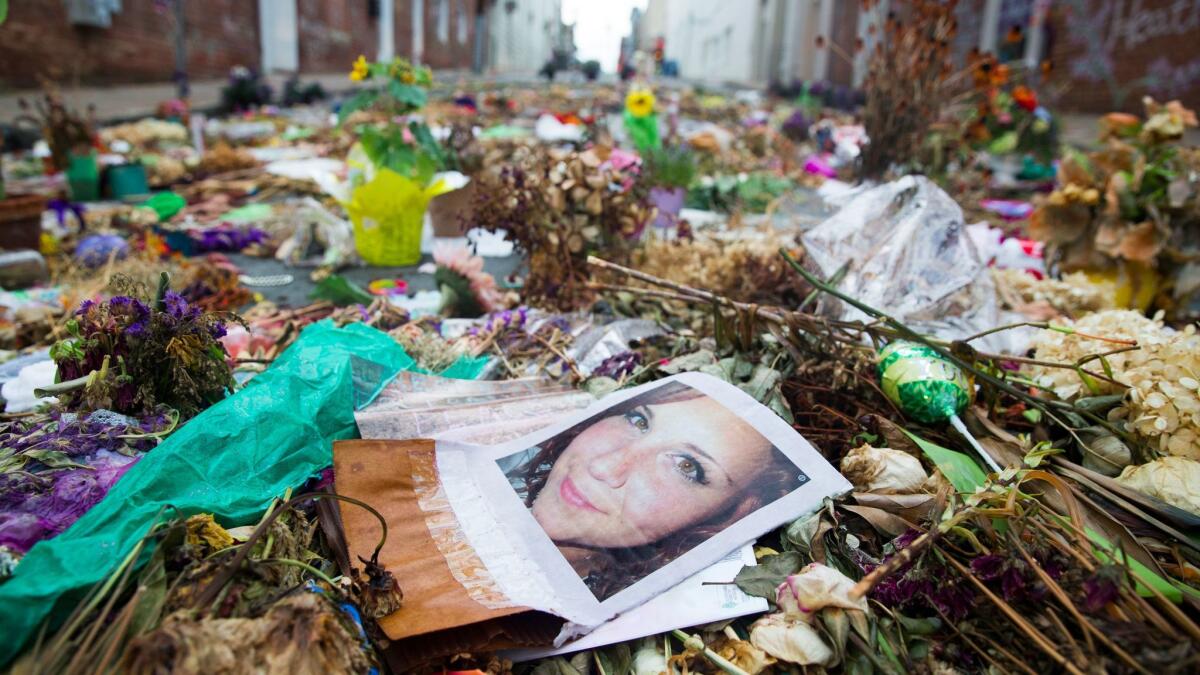 Flowers, candles and other items are placed in memory of Heather Heyer, whose image is seen in this picture, and for those affected by the violence at the site where a vehicle smashed into counter-protesters in Charlottesville, Virginia, on Aug. 24.