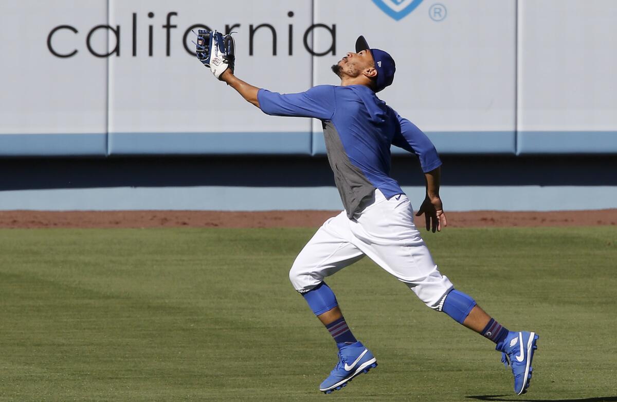 LOS ANGELES, CALIF. - JULY 3, 2020. Dodgers right fielder Mookie Betts catches fly balls.