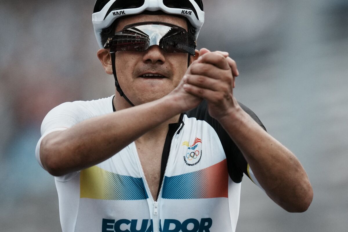 FILE - Richard Carapaz of Ecuador celebrates after winning the gold medal during the men's cycling road race at the 2020 Summer Olympics, Saturday, July 24, 2021, in Oyama, Japan. Ineos Grenadiers will be looking to make it a hat trick of victories at the Giro d’Italia, with Richard Carapaz favorite for the Italian grand tour which starts on Friday, May 6, 2022 with the first of three stages in Hungary and ends on May 29 in Verona. (AP Photo/Thibault Camus, File)