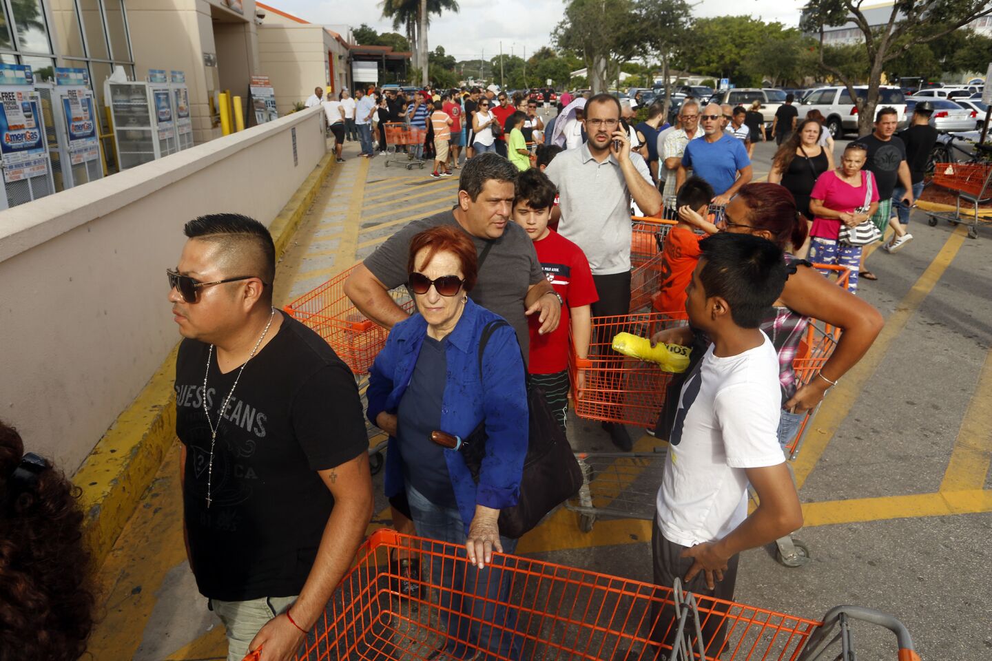 Hundreds wait in line on Friday at Home Depot in Miami to get supplies line sheets of plywood, and anything else they can find, to board up their homes. Police were on the scene to keep things orderly.