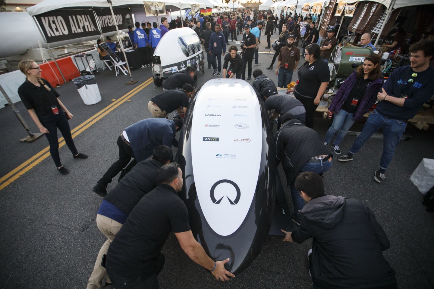 UC Irvine "UCI HyperXite" team members push their pod during the Hyperloop Pod Competition by SpaceX in Hawthorne. College students worldwide competed to test their pods on a Hyperloop track that runs three-quarters of a mile.