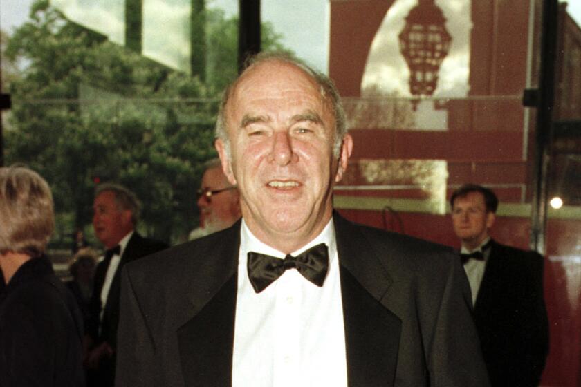 FILE - In this April 24, 1997 file photo, Clive James arrives at the Royal Albert Hall for the BAFTA award ceremony. James, an Australian journalist, joker and intellectual who had a long career as a writer and broadcaster, has died. He was 80. James’ representatives, United Agents, said he died Sunday at his home in Cambridge, and a private funeral was held Wednesday, Nov. 27, 2019. (Fiona Hanson/PA via AP, File)