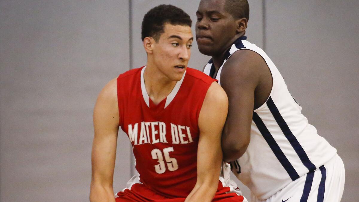 Mater Dei's M.J. Cage, left, works in the post against Mayfair during a Southern Section divisional playoff game in February 2014.