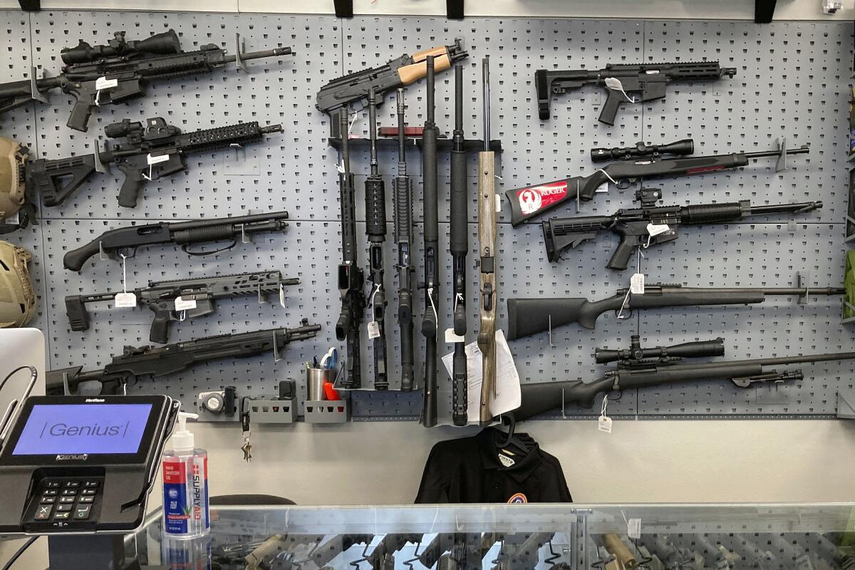 Guns displayed behind a counter at a store