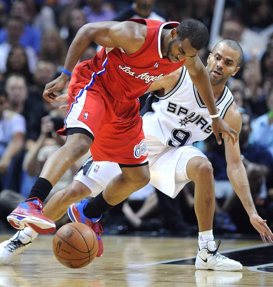 Clippers point guard Chris Paul loses control of the dribble as he's pressured by Spurs point guard Tony Parker during Game 2 on Thursday night in San Antonio.