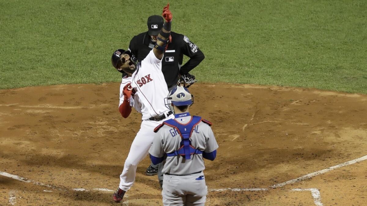 Boston's Eduardo Nunez shoots an imaginary arrow into the sky after hitting a three-run home run during the seventh inning of Game 1 of the World Series against the Dodgers on Oct. 23.