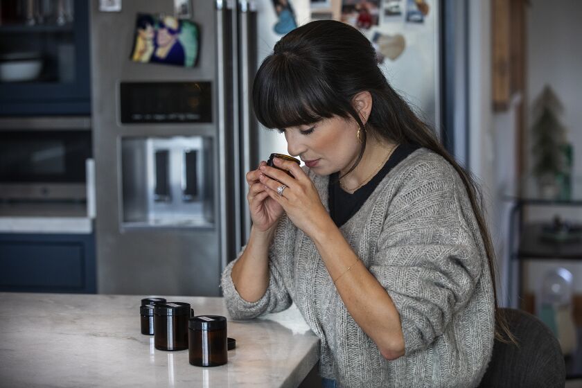 EAGLE ROCK, CA - DECEMBER 23, 2020: Mariana Castro-Salzman, 32, does smell training with essential oils at her home in Eagle Rock. Castro-Salzman lost her sense of smell after testing positive for COVID-19 back in March of 2020. To get it back, she is doing smell training, that consists of doing three rounds of smelling a variety of essential oils for 20 seconds each, twice a day. (Mel Melcon / Los Angeles Times)