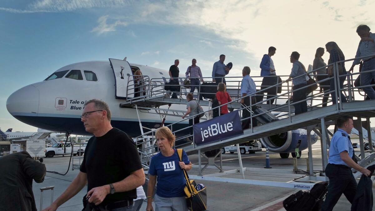 Passengers arrive on a JetBlue Airways plane from New York at Long Beach Airport in 2014. JetBlue has added routes and increased flight frequency on existing routes since Southwest began serving Long Beach.