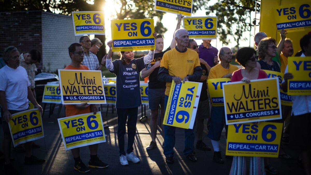 Supporters of "Yes on Prop. 6" to repeal the gas tax attend a rally outside Mimi Walters' campaign headquarters on Saturday in Irvine. Walters is running for reelection as a Republican candidate in the 45th Congressional District.