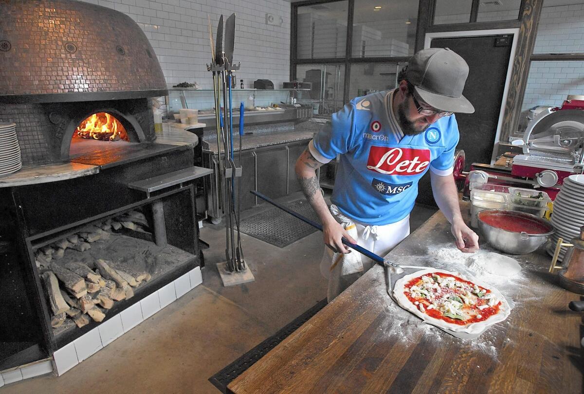 Chef Alex Moody prepares a Napoli-style margherita pizza at Settebello in Crystal Cove. Settebello is one of the first certified restaurants that ensures the pizza-making process follows the Napoli guidelines created more than 200 years ago in Italy.