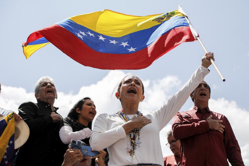 Opposition leader Maria Corina Machado waves a Venezuelan national flag during a rally to protest official results that declared President Nicolas Maduro the winner of the July presidential election, in Caracas, Venezuela, Saturday, Aug. 17, 2024. (AP Photo/Cristian Hernandez)