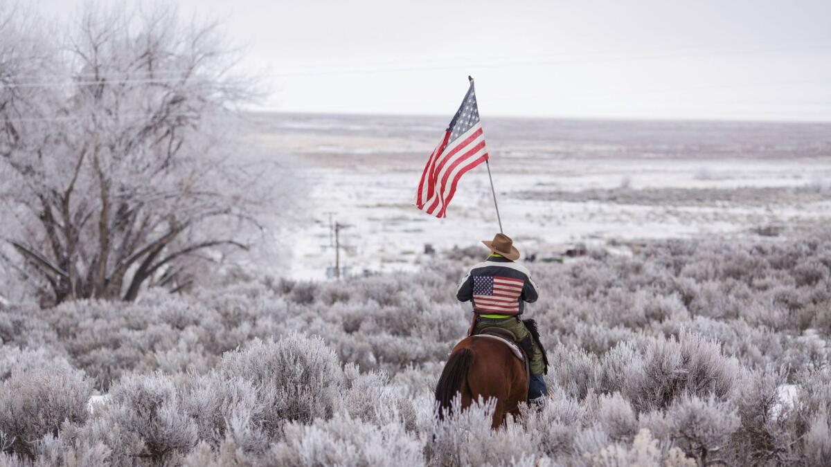Duane Ehmer rides his horse Hellboy at the occupied Malheur National Wildlife Refuge.