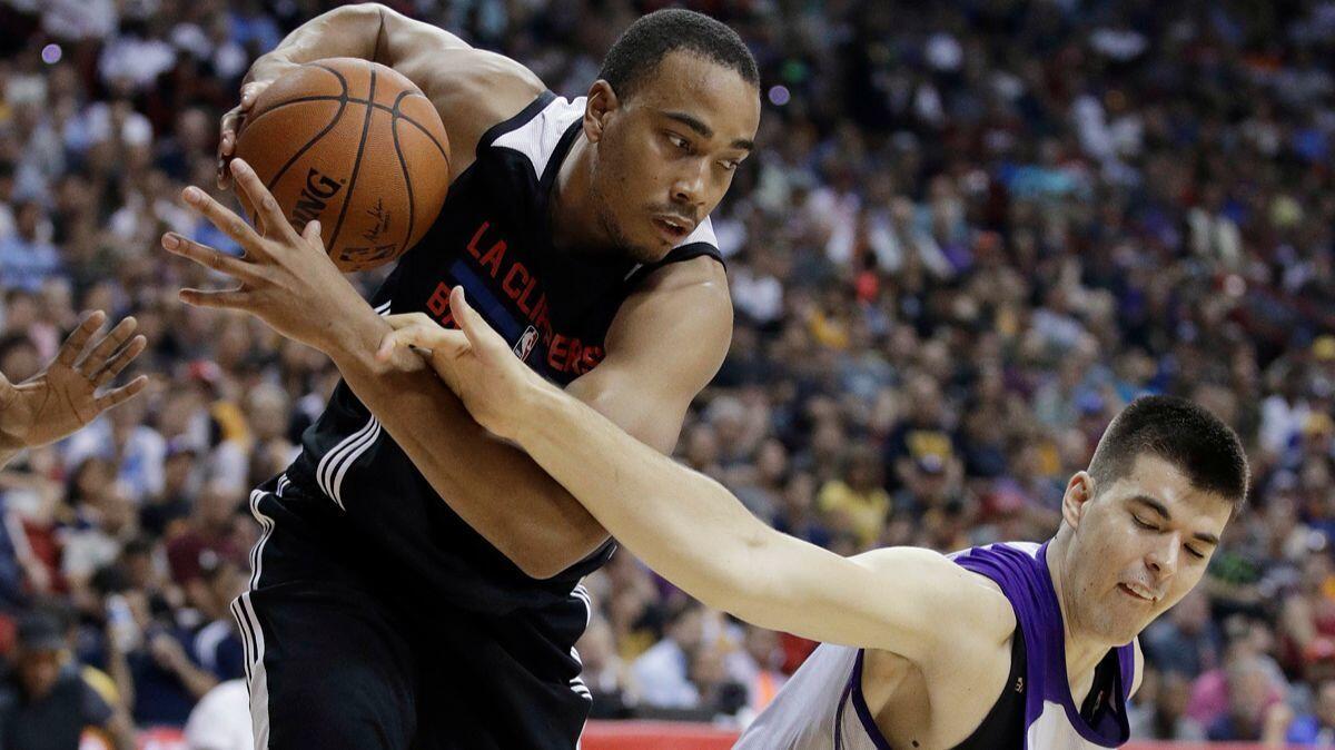 Clippers' Brice Johnson, left, pulls the ball away from Lakers' Ivica Zubac during the second half of an NBA summer league game Friday in Las Vegas.