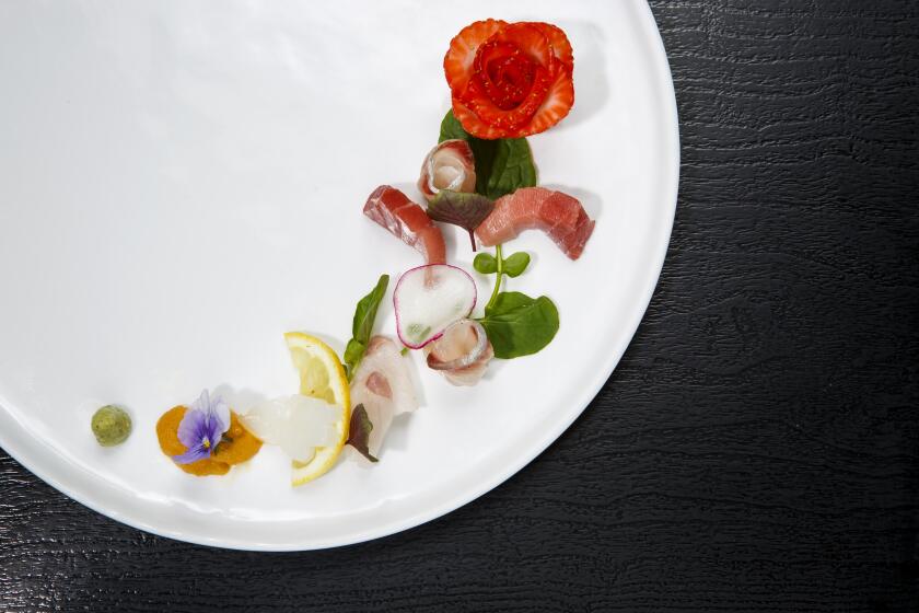 LOS ANGELES, CALIF. -- MONDAY, SEPTEMBER 5, 2016: Sashimi ?€“ strawberry, Bigeye Tuna, Kanpachi, Local Black Cod, squid, and uni at n/naka restaurant in Los Angeles, Calif., on Sept. 5, 2016. (Marcus Yam / Los Angeles Times)