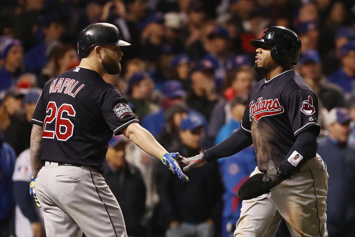 Indians slugger Mike Napoli (26) congratulates outfielder Rajai Davis (20) after Davis scores a run in the sixth inning of World Series Game 5.