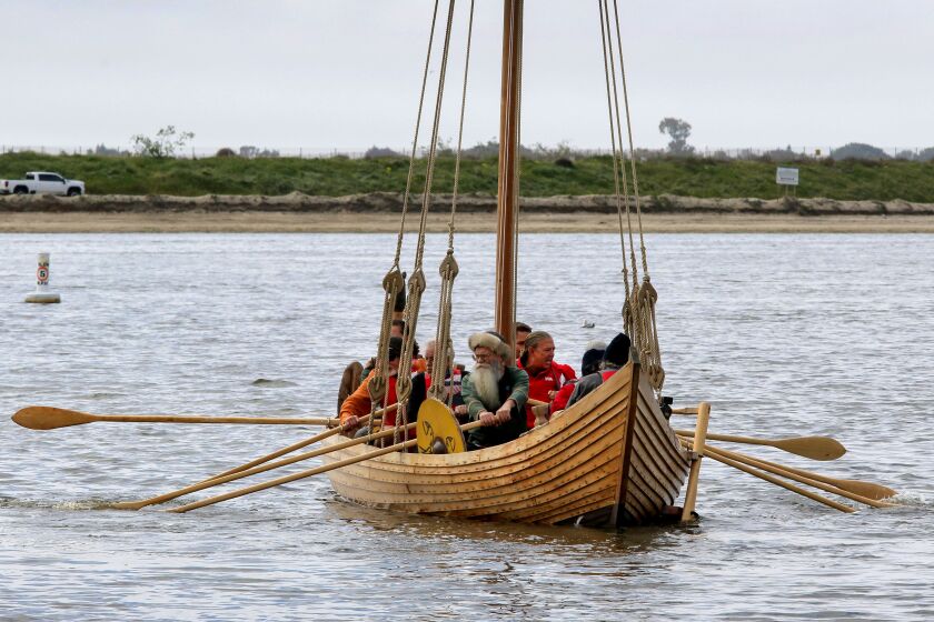 San Diego, CA - March 12: Maiden voyage of Viking ship replica Sleipnir at De Anza Cove area of Mission Bay_ Crew members, some in Viking costumes, use oars to propel the ship on Mission Bay. (Charlie Neuman / For The San Diego Union-Tribune)