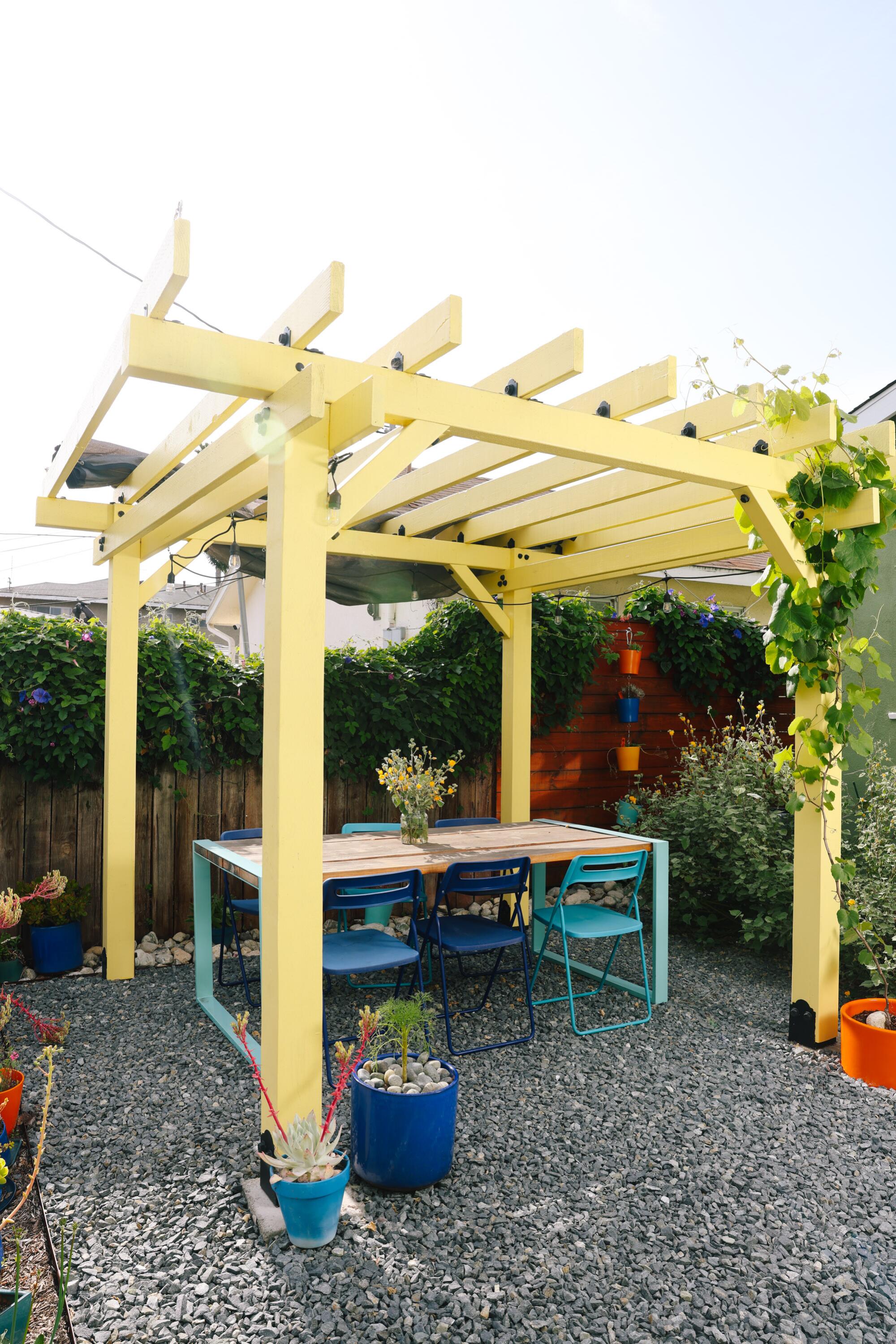 An outdoor dining area and pergola in the garden.