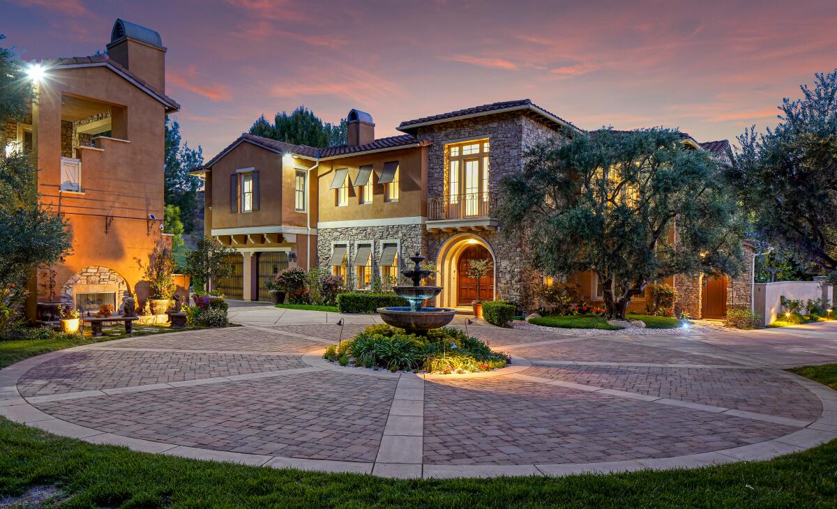 A motor court marks the front of a 3-acre Hidden Hills property