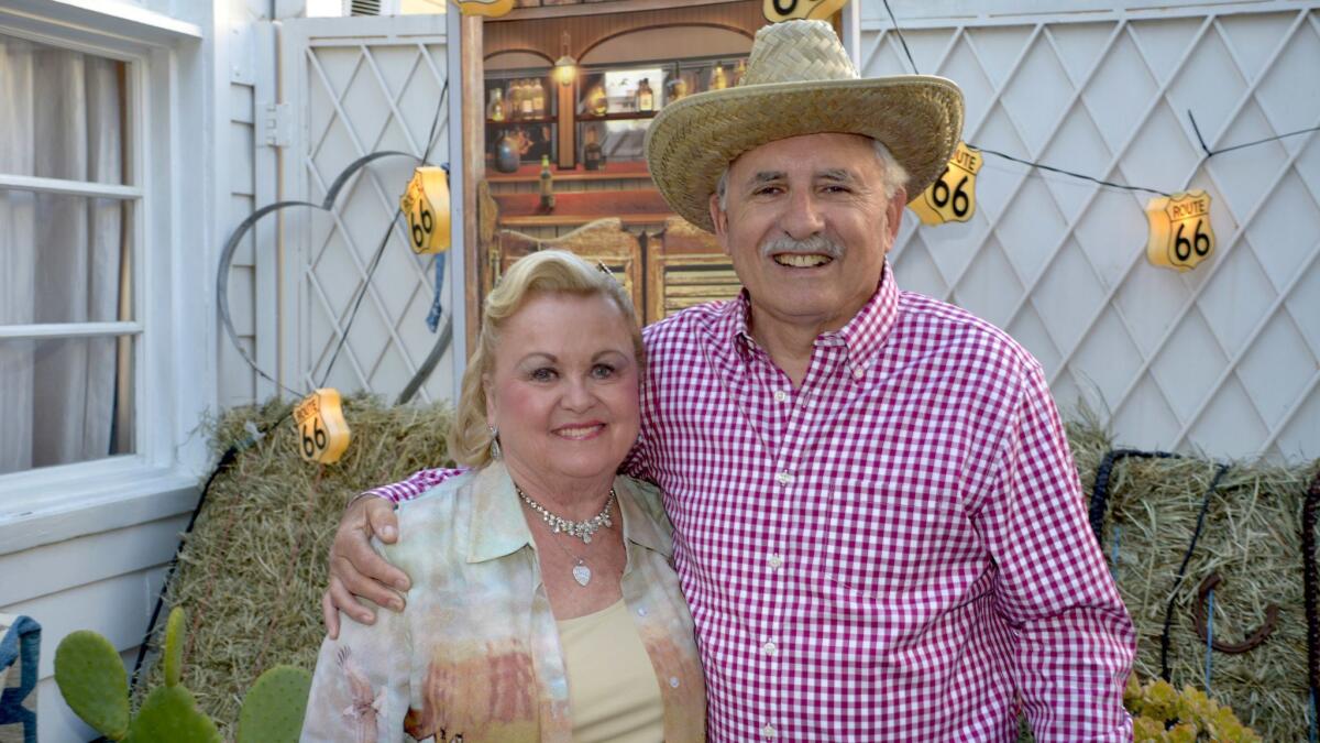 La Providencia Guild past-President Joan Chandler and Chris Gargaro ready for an evening of Western food, fun and fundraising for CHLA.