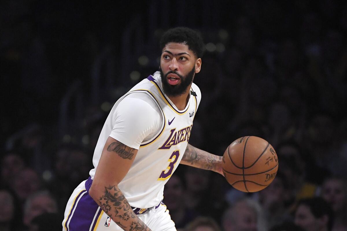 Los Angeles Lakers forward Anthony Davis dribbles during the first half of an NBA basketball game against the Detroit Pistons Sunday, Jan. 5, 2020, in Los Angeles. (AP Photo/Mark J. Terrill)