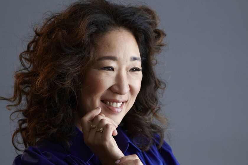 Actress Sandra Oh pulled double duty Sunday night as a Golden Globes co-host and an award recipient.