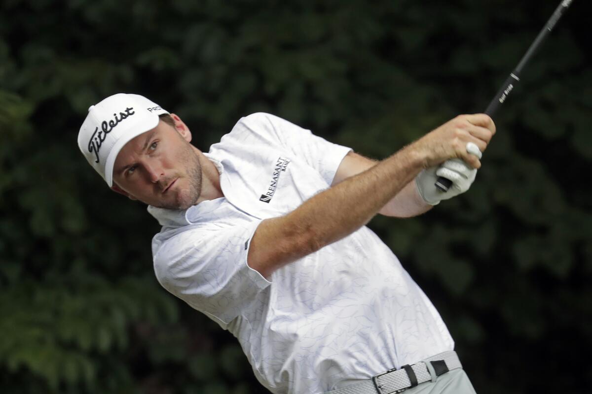 Russell Henley hits his tee shot on the second hole during the third round of the Wyndham Championship golf tournament at Sedgefield Country Club in Greensboro, N.C., Saturday, Aug. 14, 2021. (AP Photo/Chris Seward)