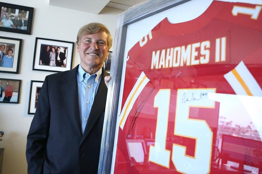 Newport Beach sports agent Leigh Steinberg will host an agent academy for prospective sports agents later this month. Steinberg stands with the framed jersey of quarterback Patrick Mahomes II of the Kansas City Chiefs, who was the #10 pick in the 2017 NFL draft.