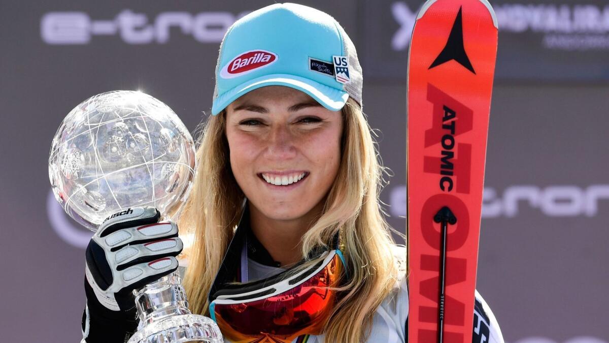 American skier Mikaela Shiffrin poses on the podium with the crystal globe trophy after winning the World Cup Finals slalom race on Saturday.