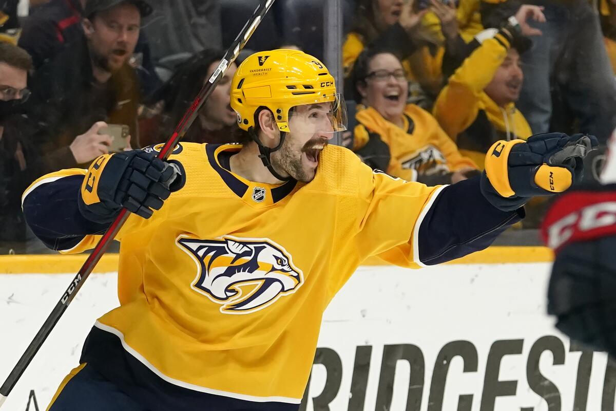 FILE - Nashville Predators left wing Filip Forsberg celebrates after scoring his third goal against the Columbus Blue Jackets during the second period of an NHL hockey game on Nov. 30, 2021, in Nashville, Tenn. The Predators have re-signed Forsberg to a $68 million, eight-year contract with an $8.5 million annual salary cap hit. The (AP Photo/Mark Humphrey, File)