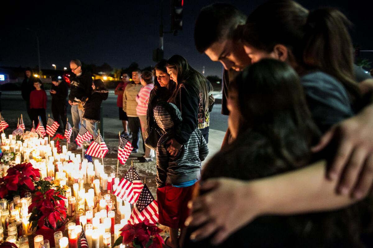 Visitors arrive to pay their respects at the site of a memorial to the victims of the recent mass shooting at the Inland Regional Center in San Bernardino.